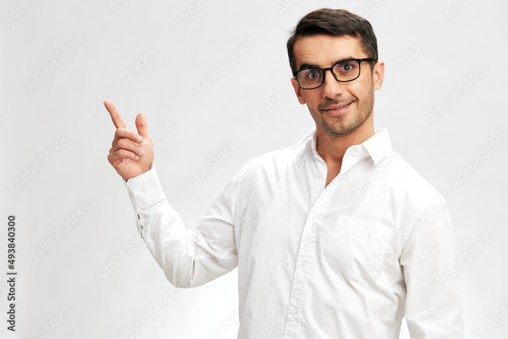 handsome man white shirt posing holding thumbs up spectacled light background handsome man white shirt posing holding thumbs up spectacled light background