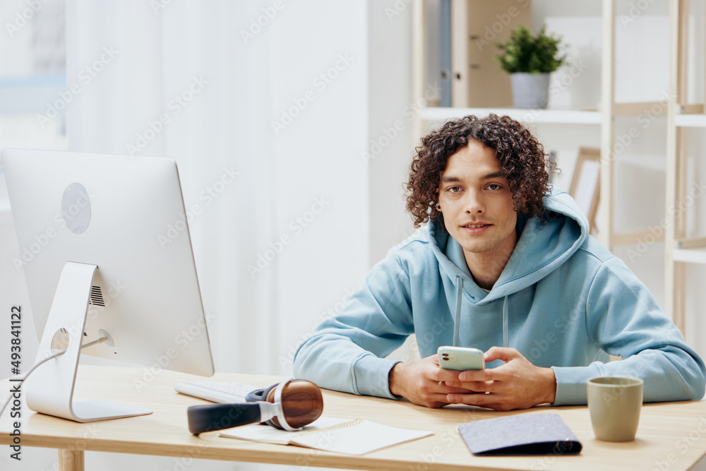 handsome guy sitting in front of the computer internet online interior handsome guy sitting in front of the computer internet online interior
