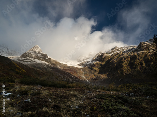 Panorama of Mont Blanc from Italy. Mountain peaks. Snowy mountain peaks after autumn rain, fog and clouds. 