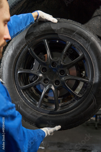 Close-up photo of car mechanic working at service station