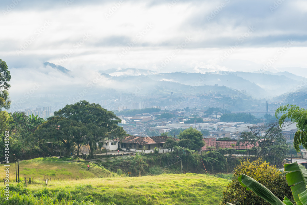 beautiful panoramic view in the municipality of Dosquebradas-Risaralda, Colombia seen from the mountains. farm near the city of Pereira on a cold morning while the beautiful golden morning sun rises.