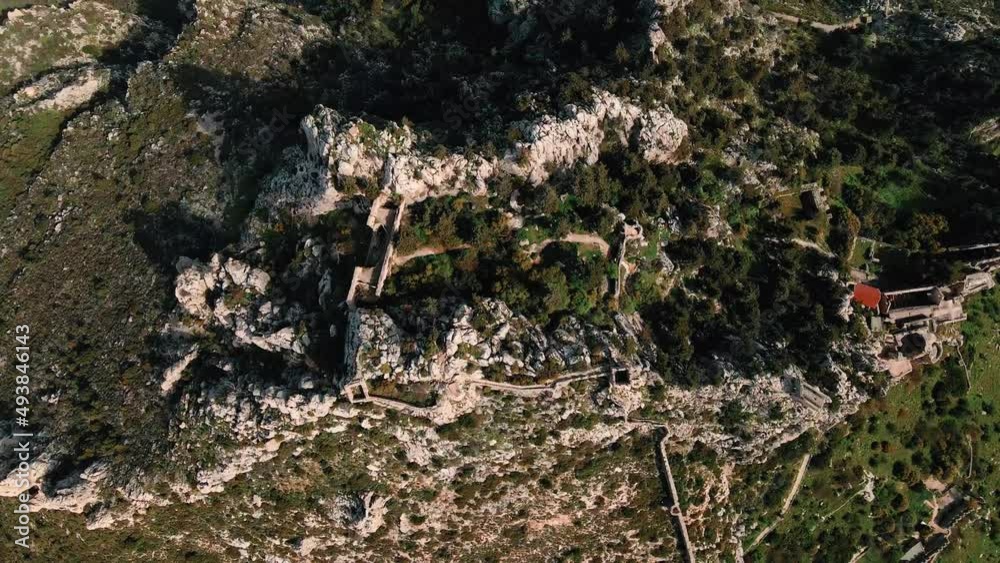 Aerial 4k Saint Hilarion Castle medieval building situated on top of mountain is surrounded with nature which has an amazing picturesque landscape of Mediterranean Sea in Kyrenia, North Cyprus Aerial 4k Saint Hilarion Castle medieval building situated on top of mountain is surrounded with nature which has an amazing picturesque landscape of Mediterranean Sea in Kyrenia, North Cyprus