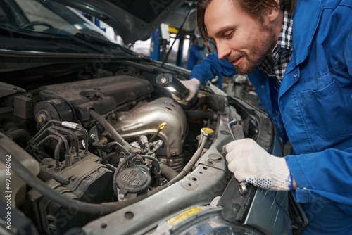 Man with tool working in service center