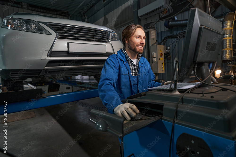 Portrait of mechanic working at computer in service center
