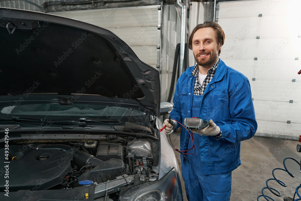 Portrait of man holding device and looking at the camera