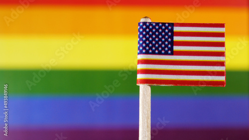 American Flag with LGBT flag in background
