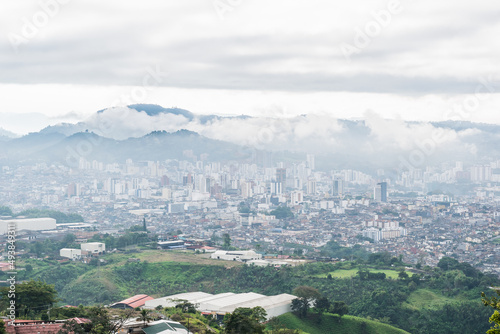 panoramic view of the city of Pereira-Colombia seen from the top of a mountain in the hours of the cold cloudy morning and with a lot of fog around.