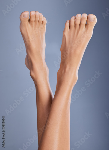 Take care of your feet. Shot of a woman with her feet in the air.