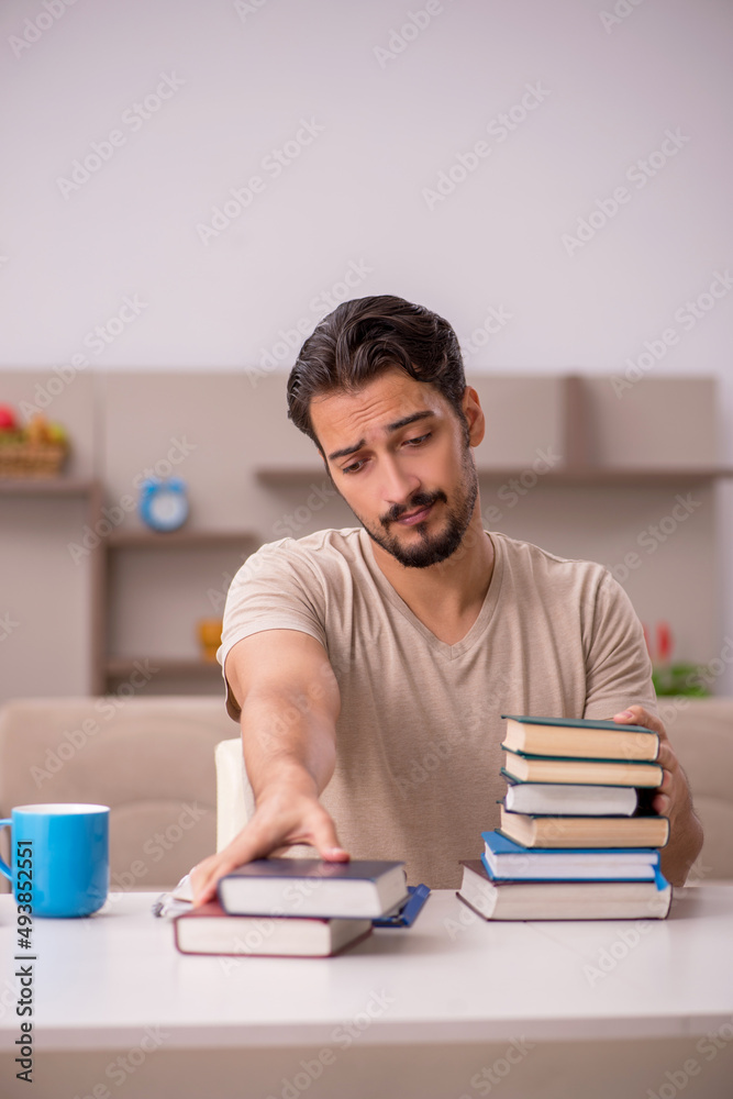 Young male student studying at home during pandemic