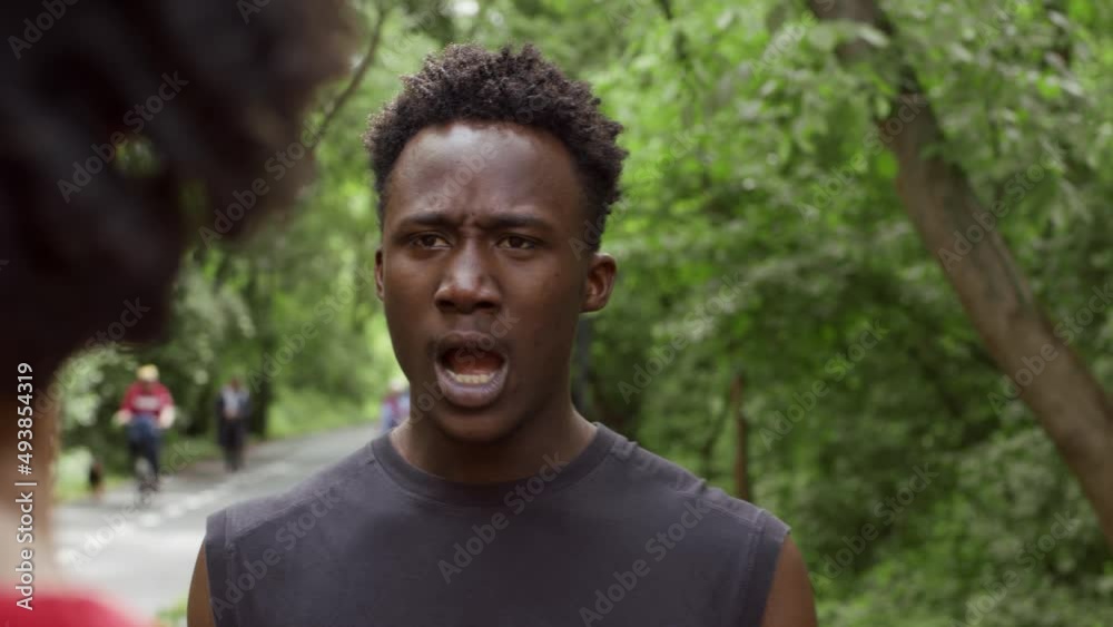 African American Aggressive Guy Shouting At His Friend Outdoors African American Aggressive Guy Shouting At His Friend Outdoors