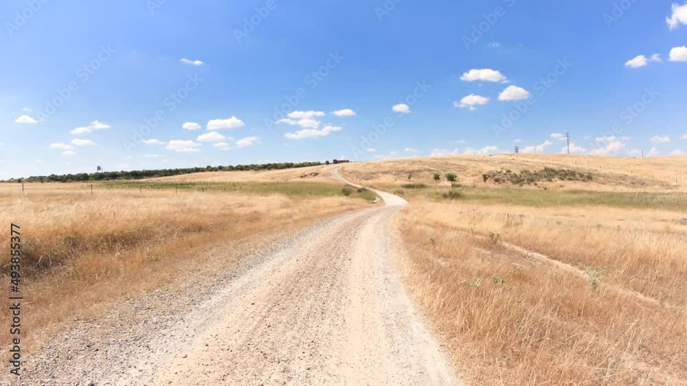 Via de la Plata, a gravel road on a summer landscape in direction to Casar de Cáceres, province of Cáceres, Extremadura, Spain - dolly Via de la Plata, a gravel road on a summer landscape in direction to Casar de Cáceres, province of Cáceres, Extremadura, Spain - dolly