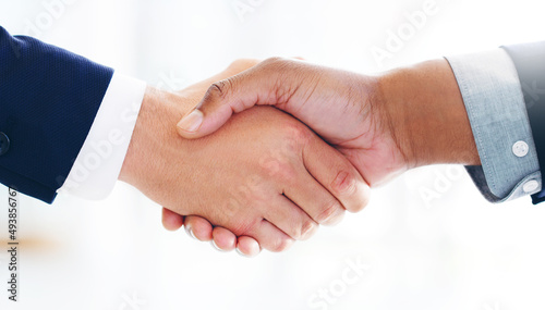 Strong partnerships are built on a strong foundation. Cropped shot of two businessmen shaking hands in a modern office.