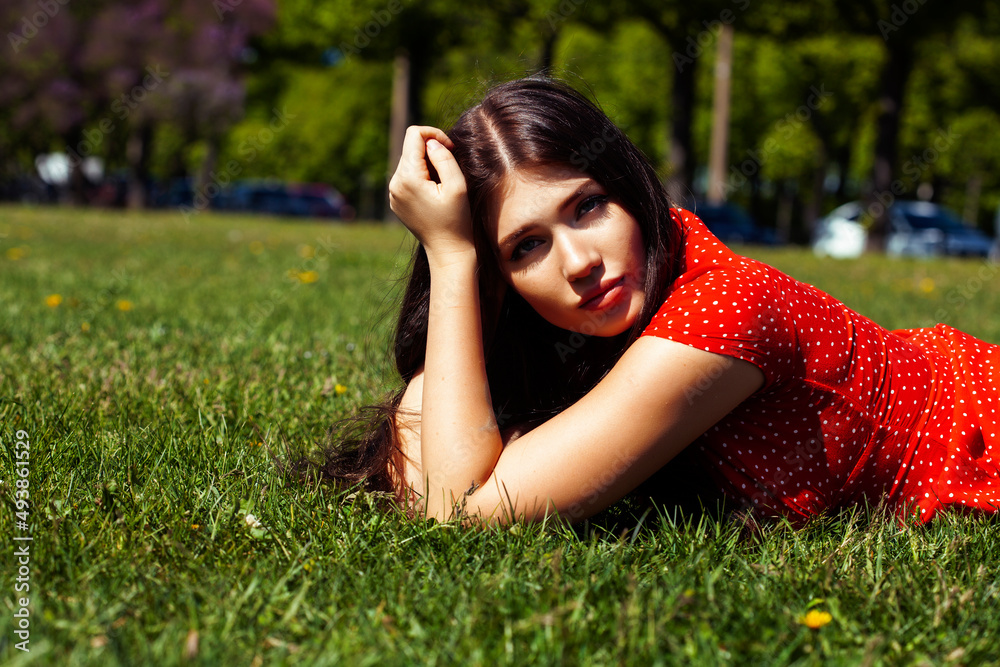 pretty young woman in red dress smiling cheerful in green park on summer sunny day, lifestyle people concept pretty young woman in red dress smiling cheerful in green park on summer sunny day, lifestyle people concept