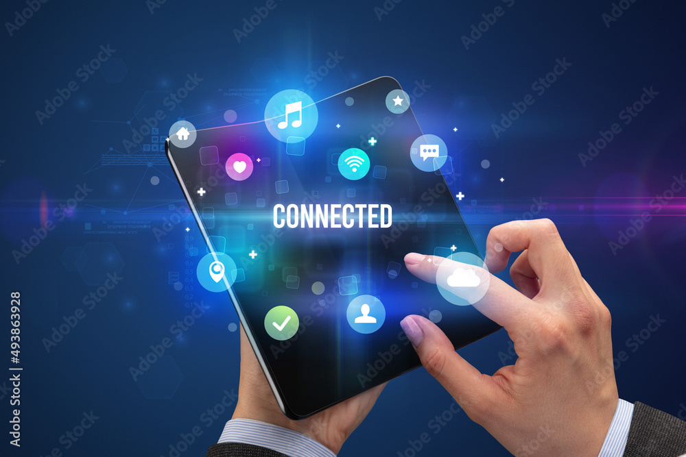 Businessman holding a foldable smartphone Businessman holding a foldable smartphone