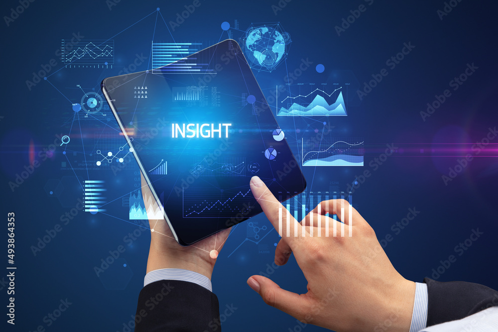 Businessman holding a foldable smartphone, business concept Businessman holding a foldable smartphone, business concept