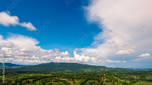 Beautiful landscape mountain green field grass meadow white cloud blue sky on sunny day. Majestic green scenery big mountain hill cloudscape valley panorama view in countryside greenery pasture