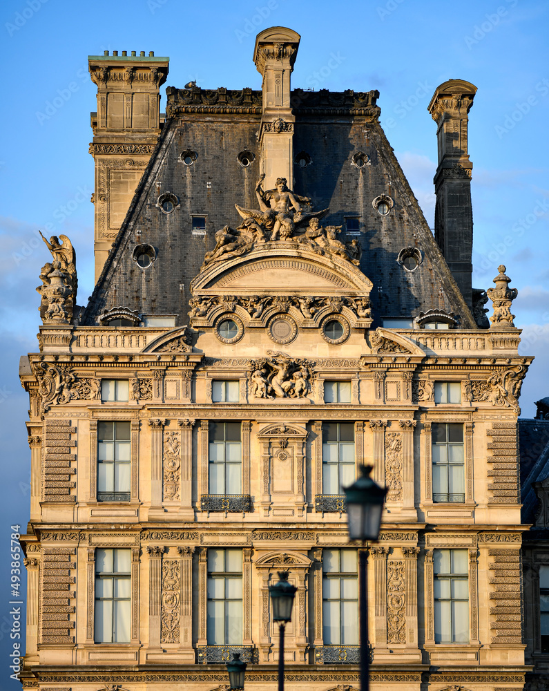 The facade of the Louvre Museum building (Paris, France). Typical architecture of a Parisian Haussmannian building 