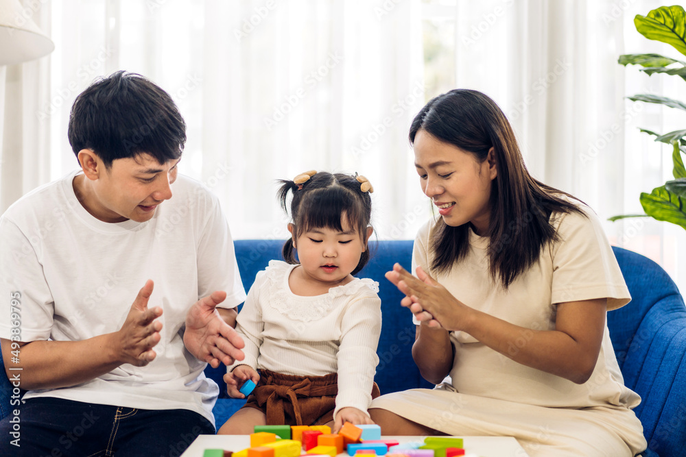 Portrait of enjoy happy love asian family father and mother with little asian girl smiling activity learn and skill brain training play with toy build wooden blocks board education game at home Portrait of enjoy happy love asian family father and mother with little asian girl smiling activity learn and skill brain training play with toy build wooden blocks board education game at home