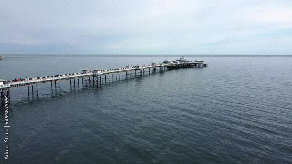 Llandudno pier Welsh Victorian boardwalk resort promenade aerial view push in shot Llandudno pier Welsh Victorian boardwalk resort promenade aerial view push in shot