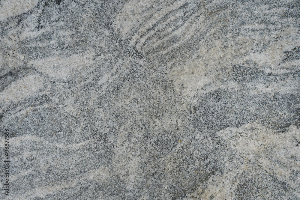 Naklejka premium Gray marble stone wall background. the abstract texture of gneiss rock.