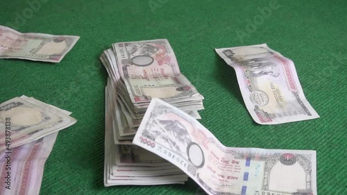 Nepali currency falling on the table. slow motion. Nepali rupee. Nepali thousand notes photo