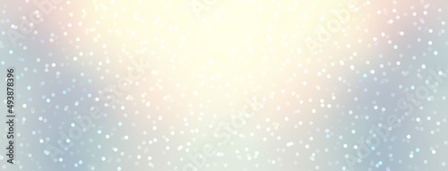 Glittering bokeh in bright shine on light blue background. New year holiday empty banner.