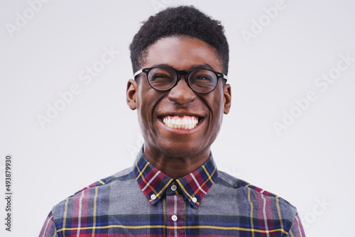 Lifes better when youre smiling. Studio shot of a young man making a funny face against a gray background.