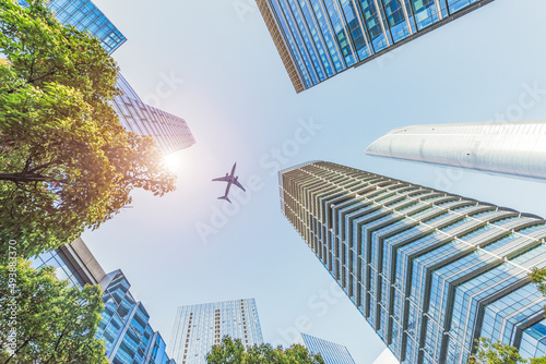 The plane flew over the roof of the office building