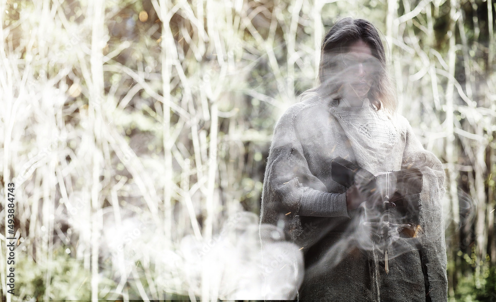 Fairy magician. A sorcerer with a glass sphere, a magical spell and a ritual. Elder with a staff and a cross in the forest. Black and white magic. A spell in an old book. Fairy magician. A sorcerer with a glass sphere, a magical spell and a ritual. Elder with a staff and a cross in the forest. Black and white magic. A spell in an old book.