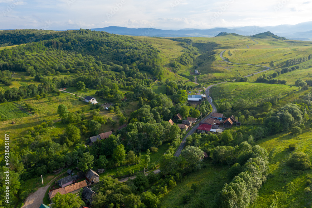 Flying over a village in Transylvania, Romania by drone