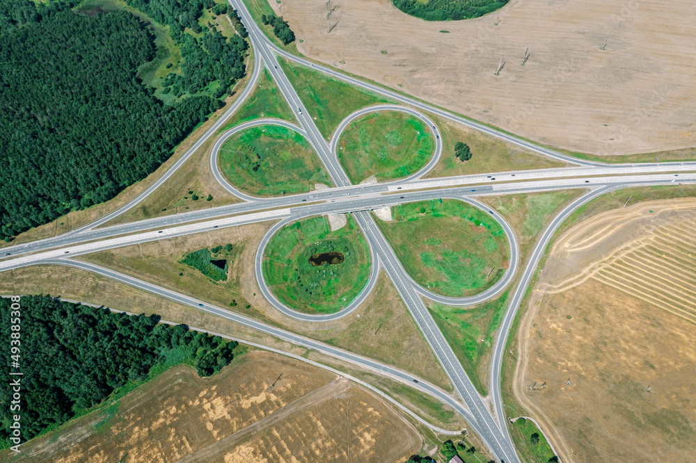 highway road junction. aerial drone view of cloverleaf interchange.