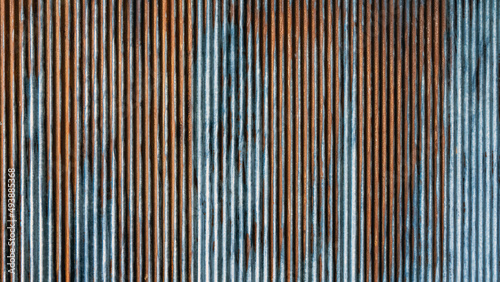 Artistic of old and rusty zinc sheet wall. Vintage style metal sheet roof texture. Pattern of old metal sheet. Rusting metal or siding. Corrosion of galvanized. Background and texture in retro concept