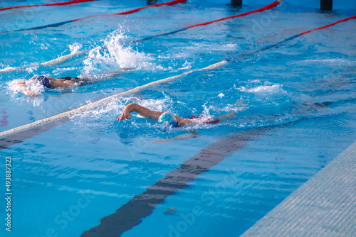 Men compete in swimming in the pool.