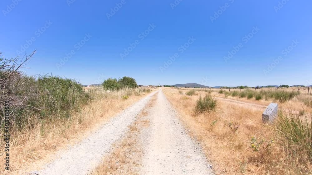 Via de la Plata, a gravel road on a summer landscape approaching Valdesalor, province of Cáceres, Extremadura, Spain - dolly Via de la Plata, a gravel road on a summer landscape approaching Valdesalor, province of Cáceres, Extremadura, Spain - dolly