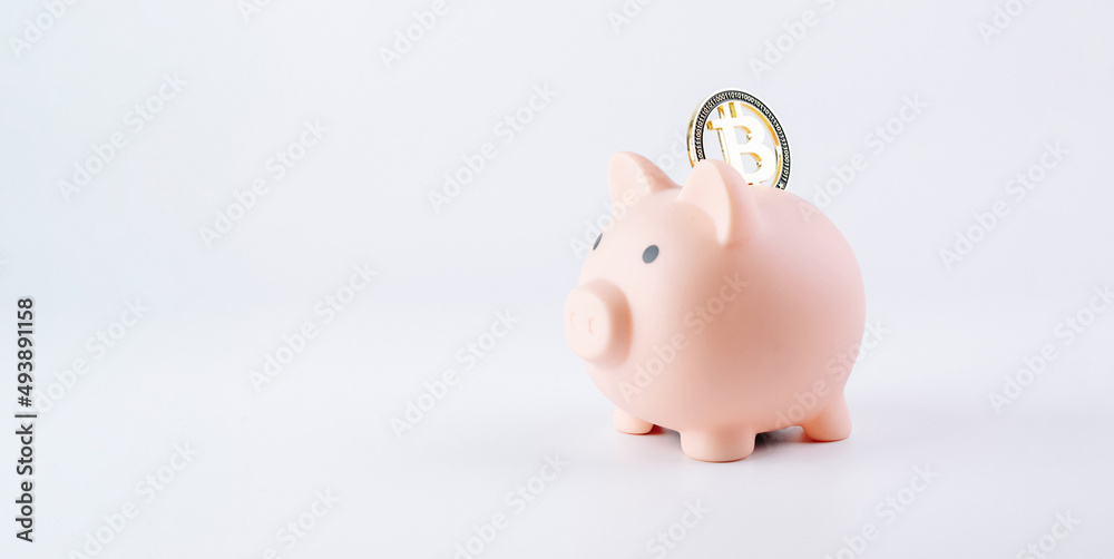 Obraz premium Save currency bitcoin. Pink pig bank with golden bit coin money BTC on white background. Save money investment and business finance.