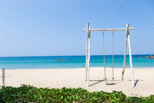 Wooden swing on beautiful sand beach in South of Thailand, summer holiday and vacation destination, tropical beach, summer outdoor day light, relax by the sea © sirirak