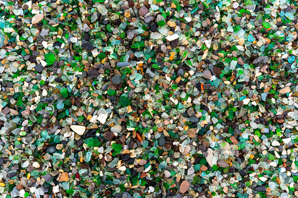 Glass Bay in Vladivostok. Sea-polished colored glass on the beach. Background, texture