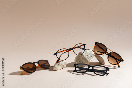 Sunglasses and glasses sale concept. Trendy sunglasses on beige background. Trendy Fashion summer accessories. Copy space. Summer sale. Optic store discount poster. Minimalism photo