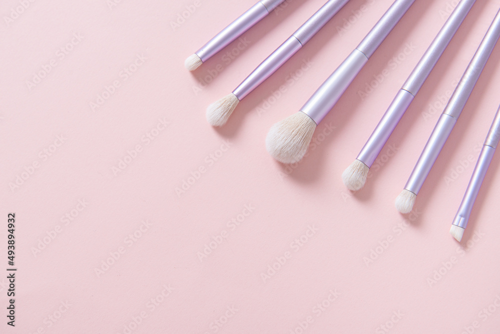 Professional makeup tools brushes on pastel pink background. Set of glamour violet makeup brushes. Magazines, social media. Visagist tools. Top view, copy space. Creative flat lay. Cosmetics products Professional makeup tools brushes on pastel pink background. Set of glamour violet makeup brushes. Magazines, social media. Visagist tools. Top view, copy space. Creative flat lay. Cosmetics products