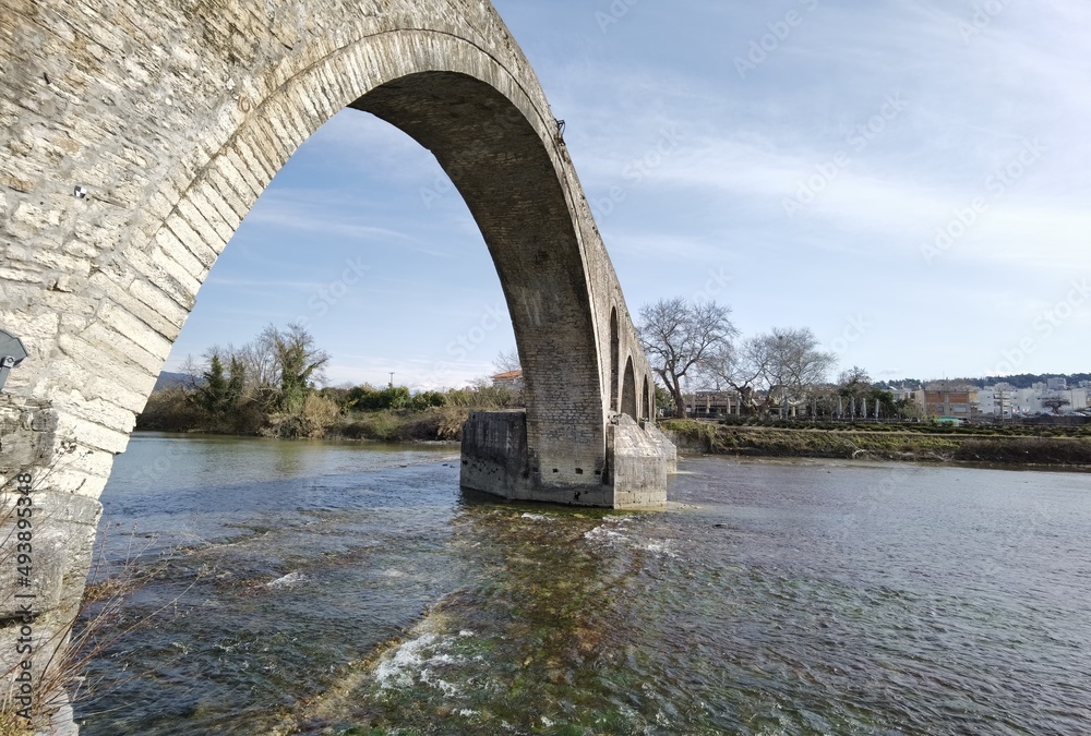 arta city old arched bridge of stones  through arahthos river greece