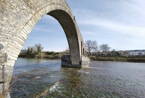 arta city old arched bridge of stones  through arahthos river greece © sea and sun