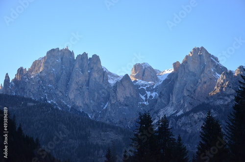 Photos of the snowcapped Dolomites during a winter trip and the small villages in the mountain valleys on a sunny, cold day