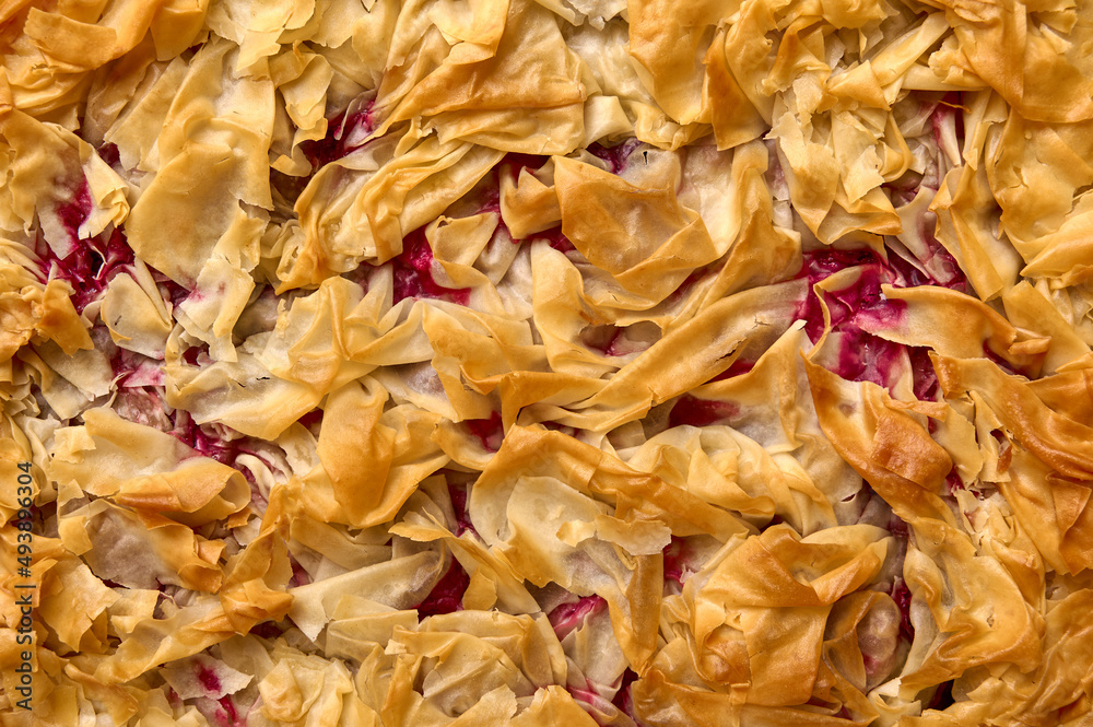 Food background homemade cherry pie from filo dough. Top view. Close up Food background homemade cherry pie from filo dough. Top view. Close up