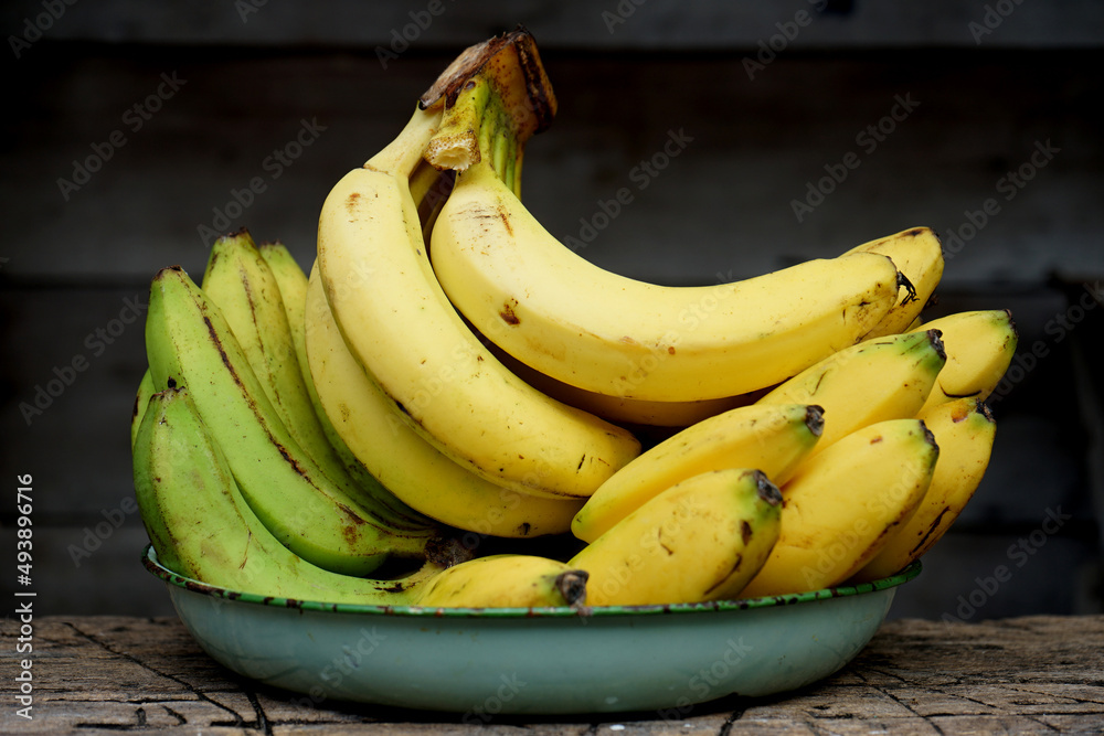 ripe cavendis bananas on a wooden table