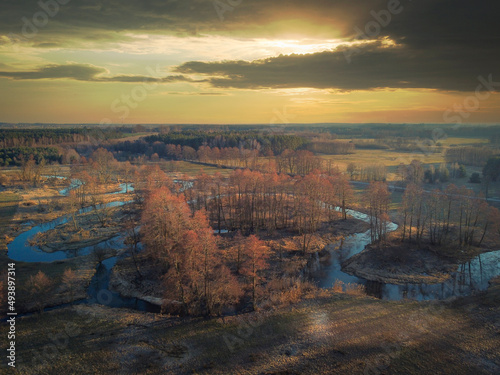 A winding river seen from above in the rays of the setting sun.