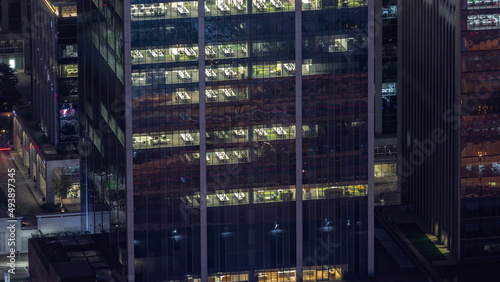 Windows in offices of a high class building at night timelapse