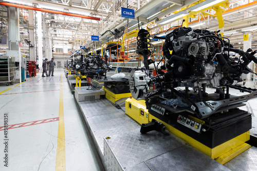 Photo of car bodies are on assembly line. Factory for production of cars. Modern automotive industry