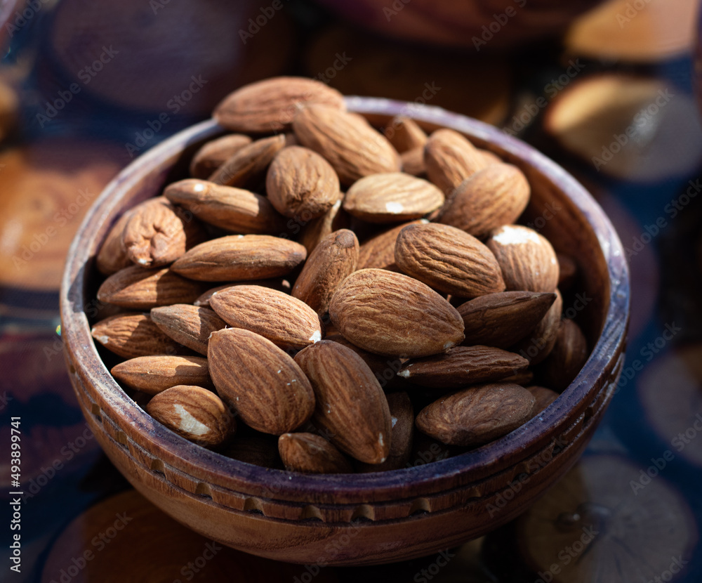 almonds in a wooden bowl almonds in a wooden bowl