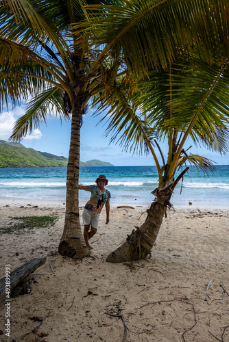 woman tourist near a fishing boat with a net on a sandy beach in the Dominican Republic 