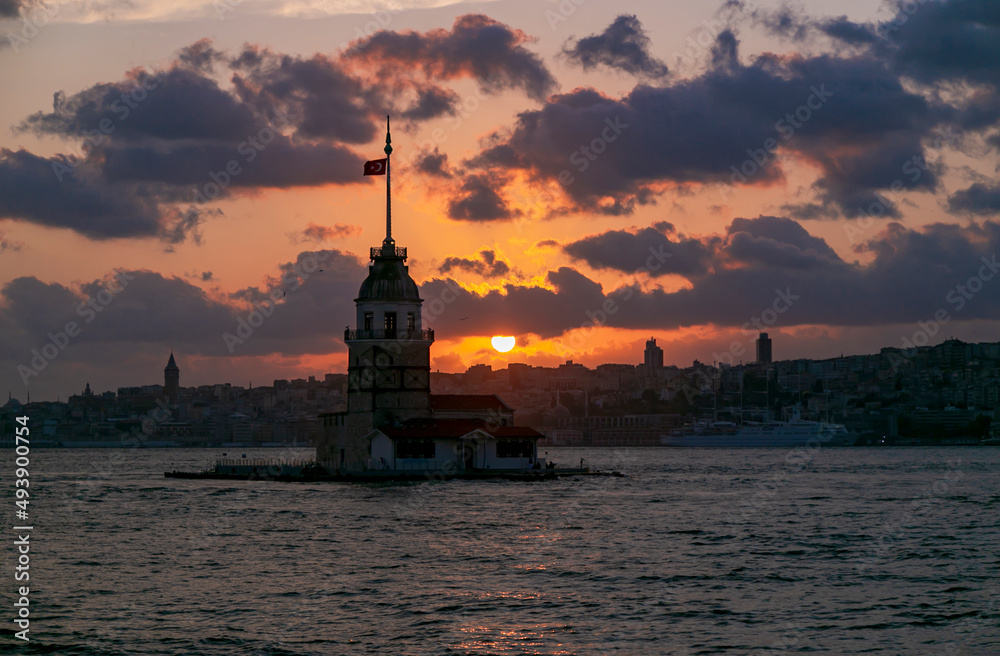 Maidens Tower at sunset, İstanbul. Beautiful clouds with blue sky. Historical light house of İstanbul Maidens Tower at sunset, İstanbul. Beautiful clouds with blue sky. Historical light house of İstanbul
